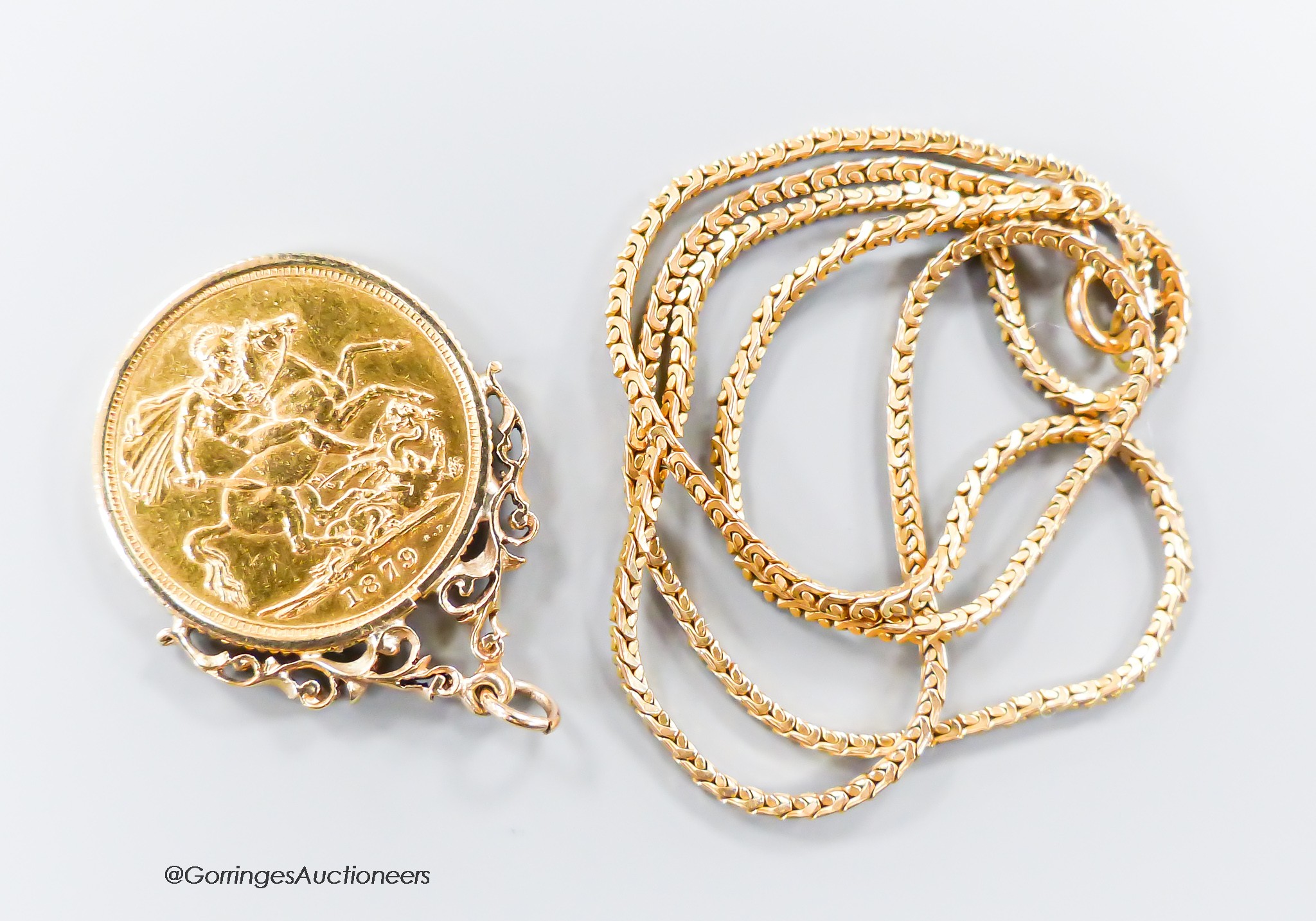 A Victorian 1879 gold sovereign, now in a yellow metal pendant mount, on a 9ct gold chain, gross 15.3 grams.